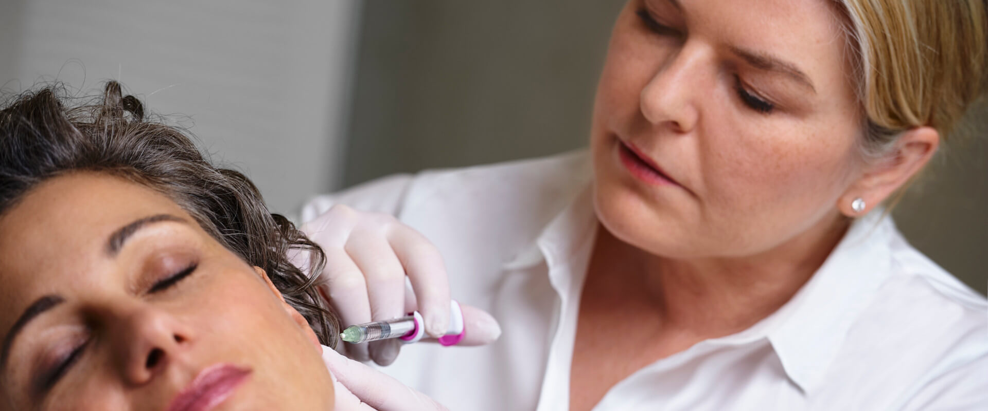 Behandlung am Ohrläppchen einer Patientin